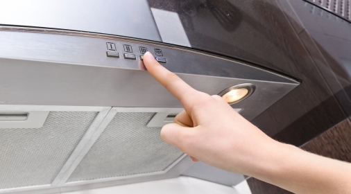 Cooker hood with someone pressing a button