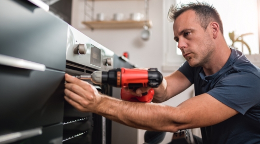 Man building kitchen and using a cordless drill